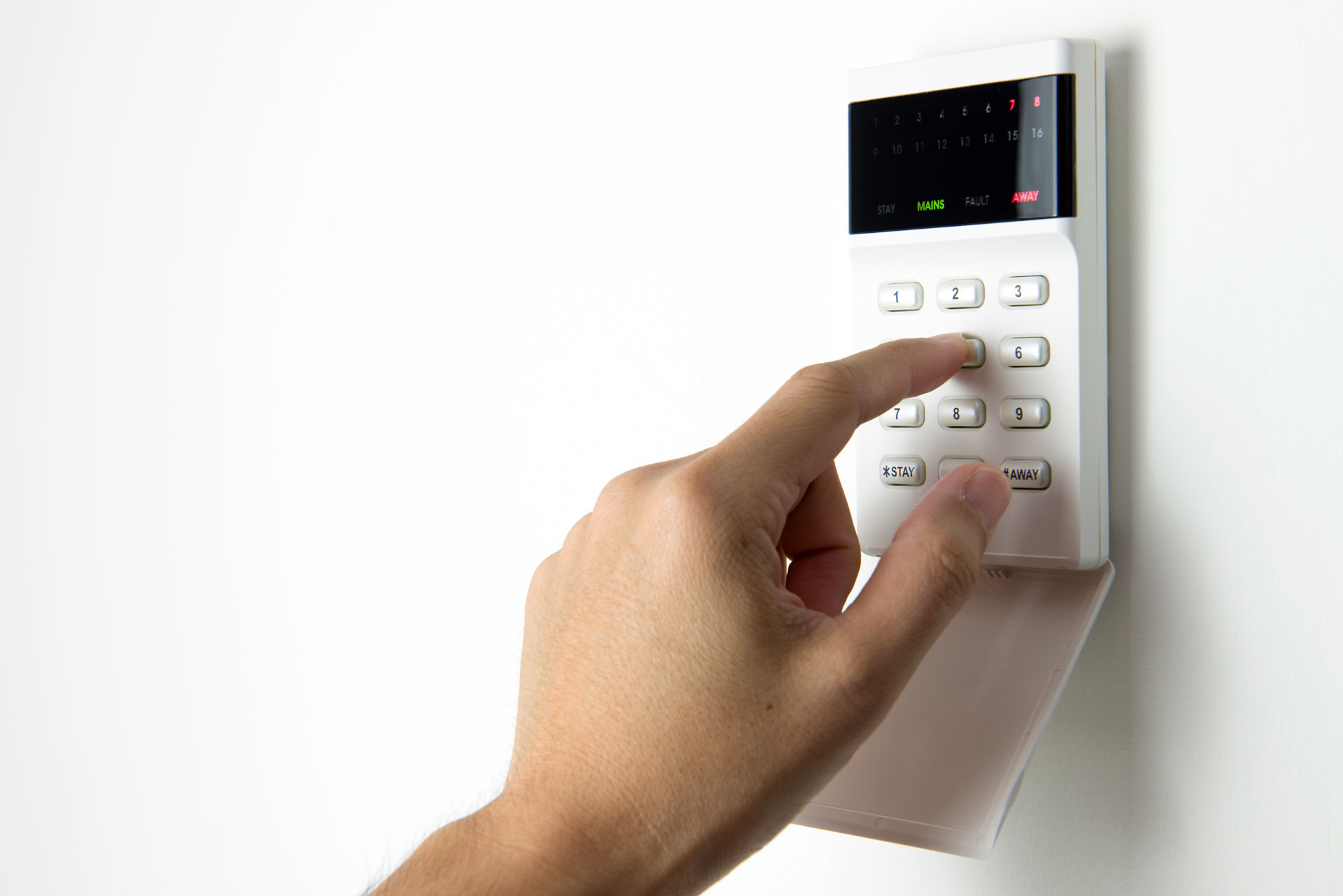 person entering code into an alarm system
